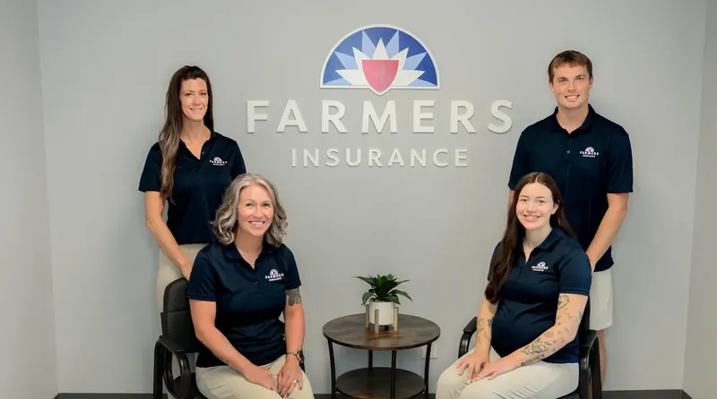 The Tina Gregory Agency team in front of the Farmers Insurance sign