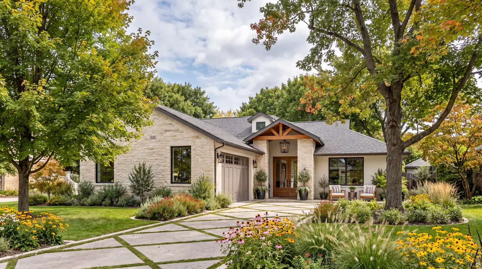 A stone family home with fall landscaping